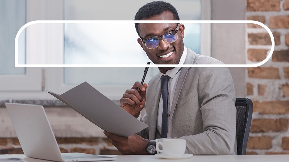 Man reads a document while sitting at his desk 