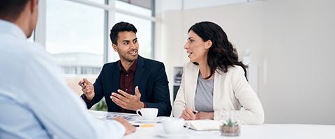 A man and woman converse in an office