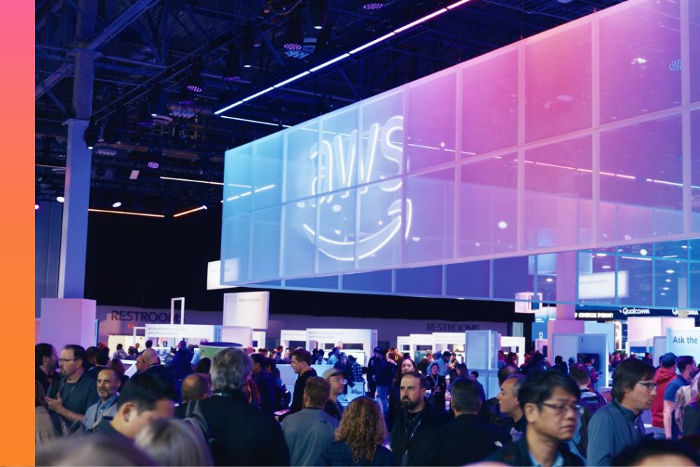 High shot of AWS re:Invent showing a room full of attendees. 