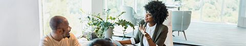 Two people having a conversation in an office setting