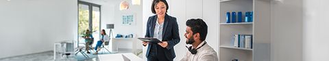 Two people having a conversation in an office environment