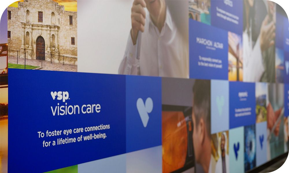 Wall mural photo montage of VSP logos and eye care doctors and patients. 