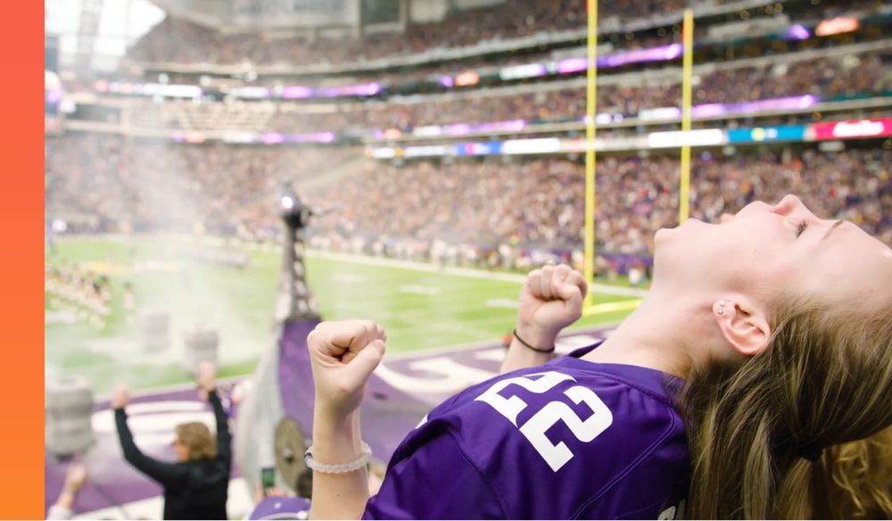 Girl cheering at Vikings stadium 