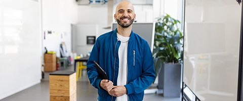 Smiling man in an office lobby