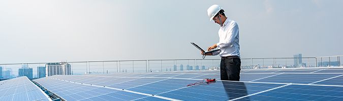 Technician working on solar panels in a field