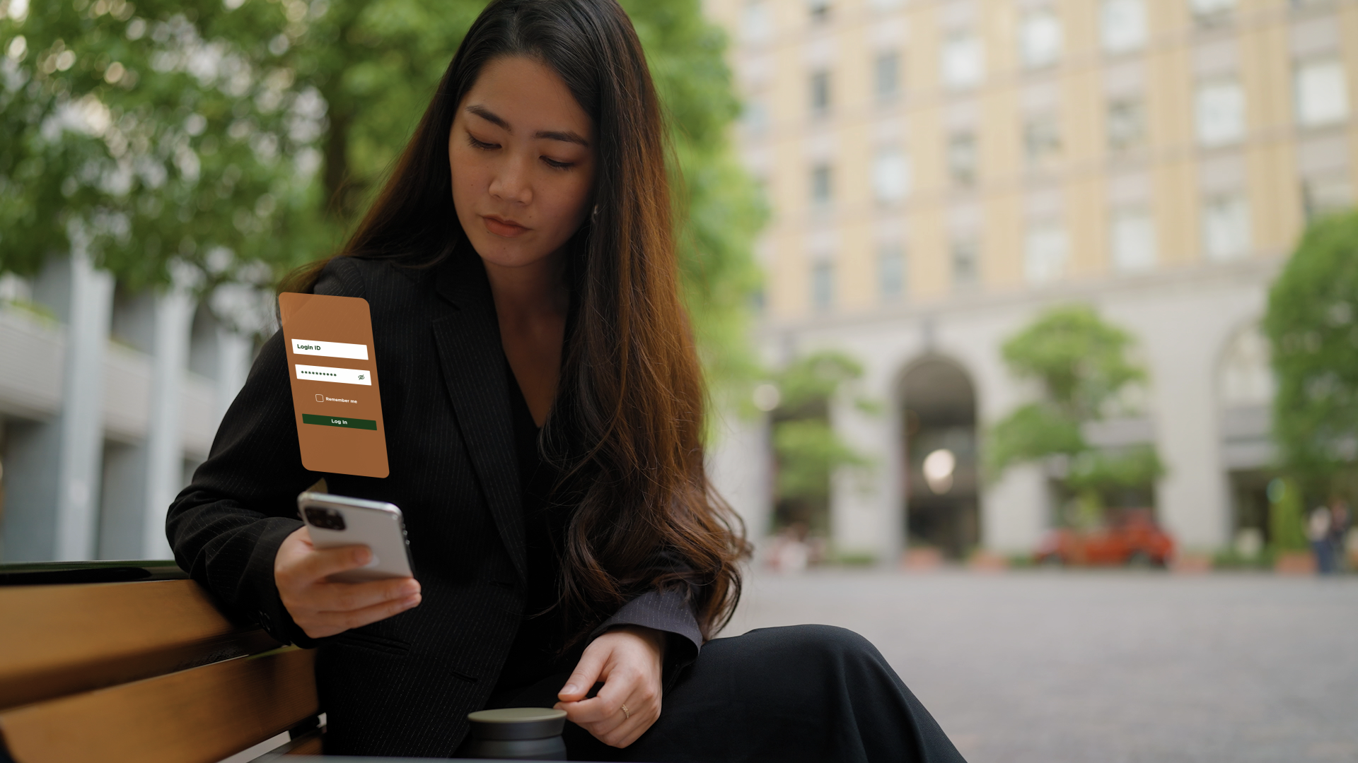 Woman sitting on a bench looking at bank account information on a cell phone