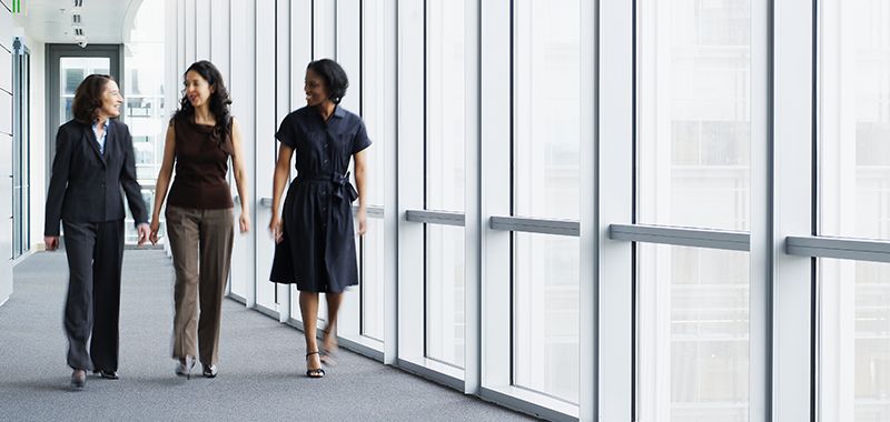 Women walking in corporate offices hallway