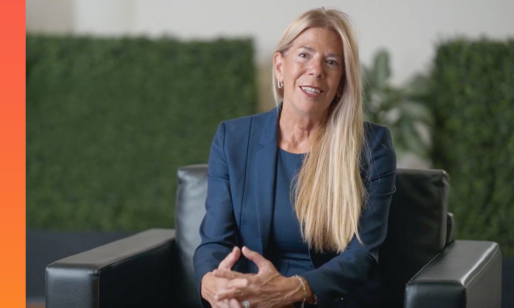 Businessprofessional in blue suit sits in a leather chair and discusses something. 