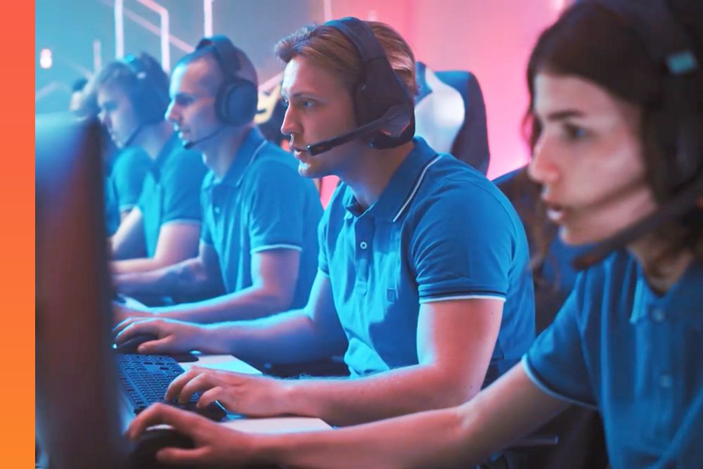 Multiple people in the same shirt and head set sitting at a row of desktop computers