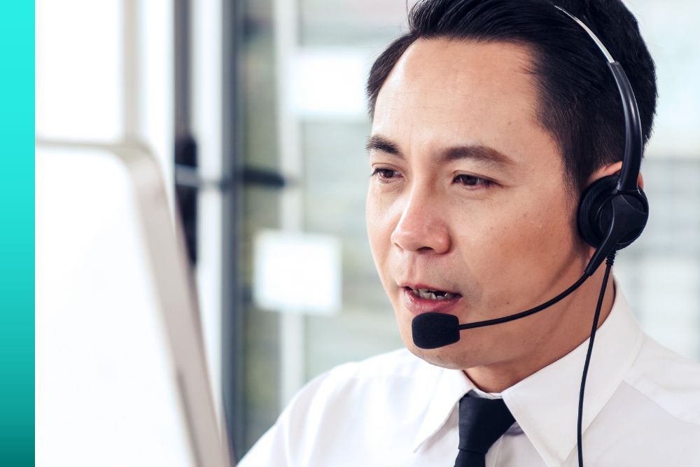 Man in a white shirt and tie while talking on headset