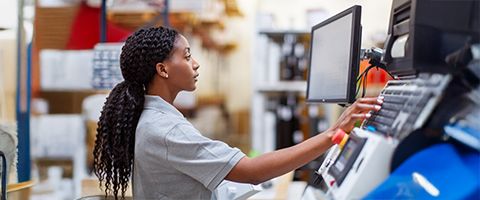 A serviceperson works on a computer system in a facility.