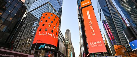 Digital graphic featuring the word LUMEN with a registered trademark symbol above a white "x" and the Nasdaq name and icon. The design suggests a collaboration or partnership between Lumen and Nasdaq. The background is a smooth gradient transitioning from orange at the top to pinkish red at the bottom, creating a modern and vibrant look. Clean typography and minimal elements emphasize the corporate and technology-oriented nature of the announcement.