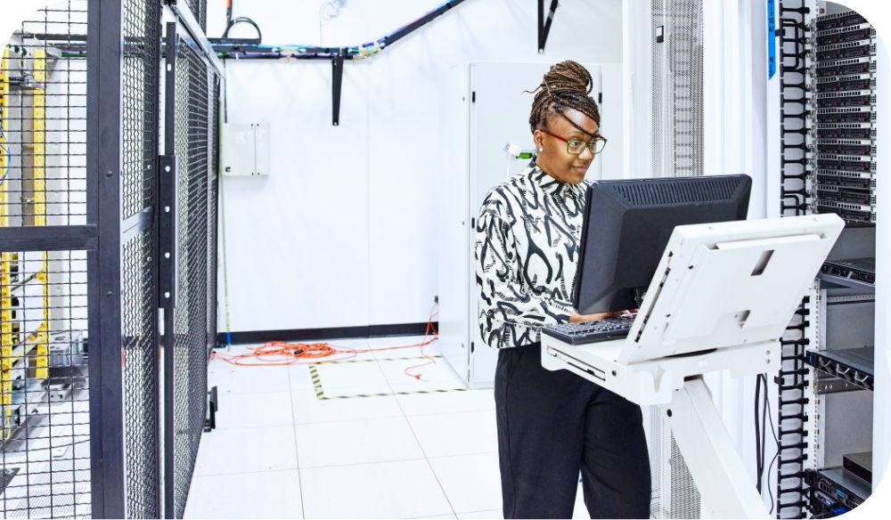 Businessperson on computer in a server room