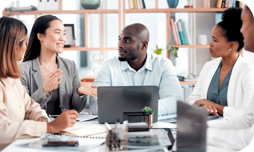 Businesspeople at a conference table having a discussion.