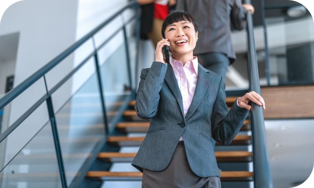 Woman walking down stairs while she is talking on her cell phone