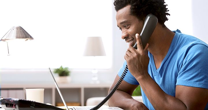 African-American man on the phone in his home office