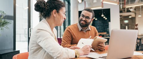 Two people meeting at a conference table