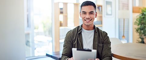 Smiling person with tablet.