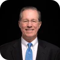 Portrait of Peter Brown infront of a plain black background