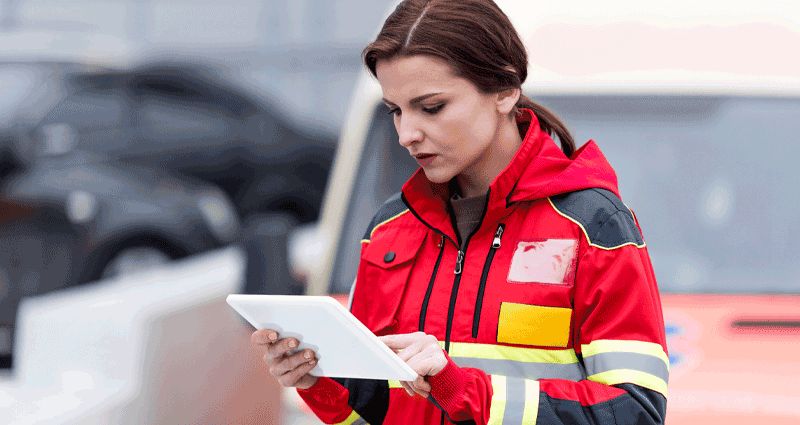 Woman in red jacket reading tablet