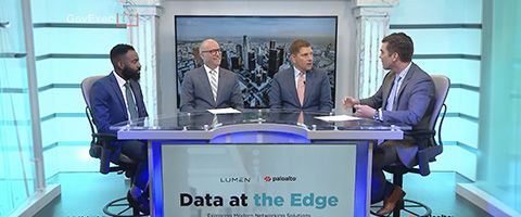 Four people seated around a table participating in a panel discussion in a television studio with a sign that reads “Data at the Edge” and logos for Lumen and Palo Alto Networks