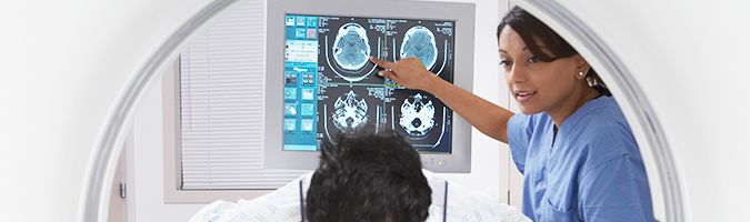 woman pointing to image of brain