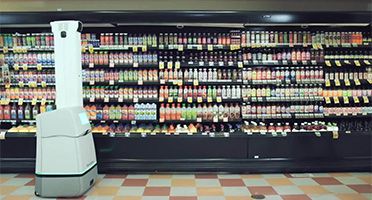 Robot taking inventory in a grocery store aisle