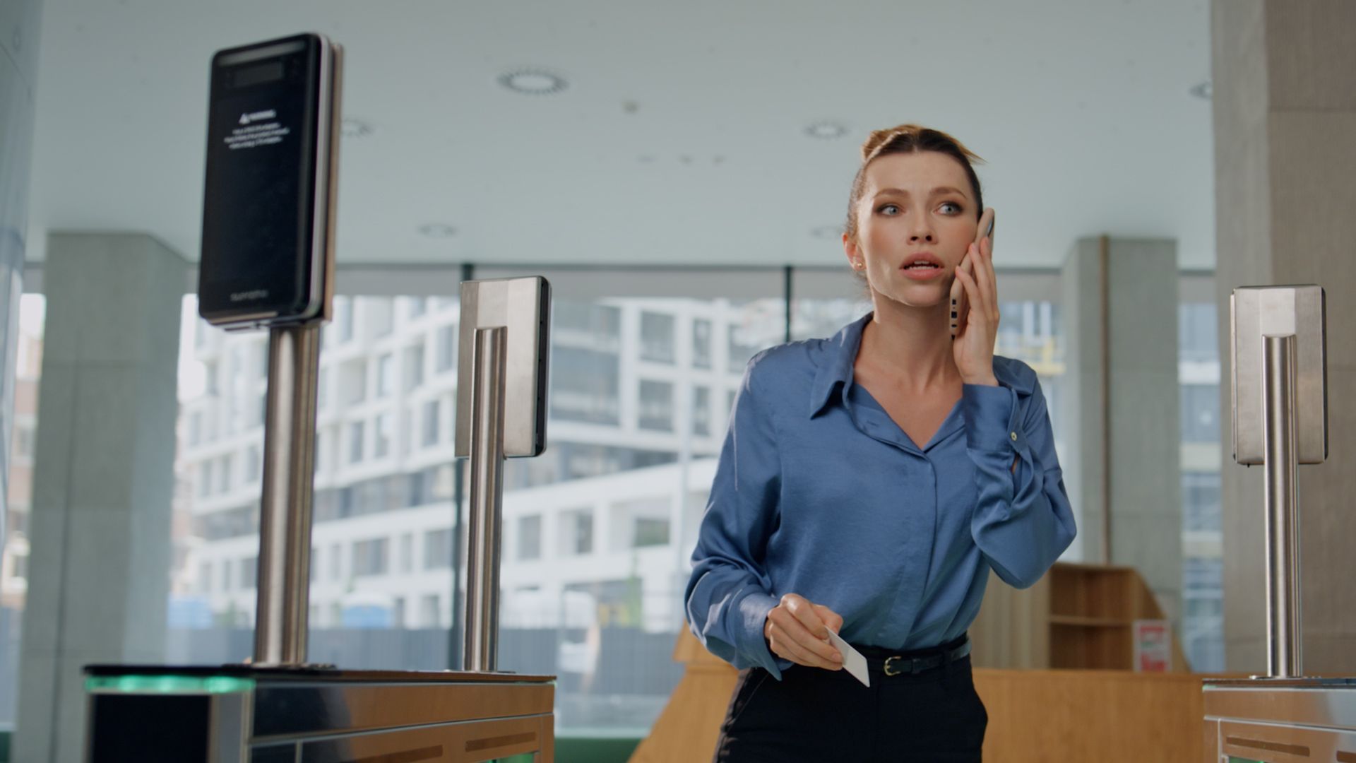 An alarmed woman in an office uses Lumen Specialty Lines to initiate a secure emergency call.