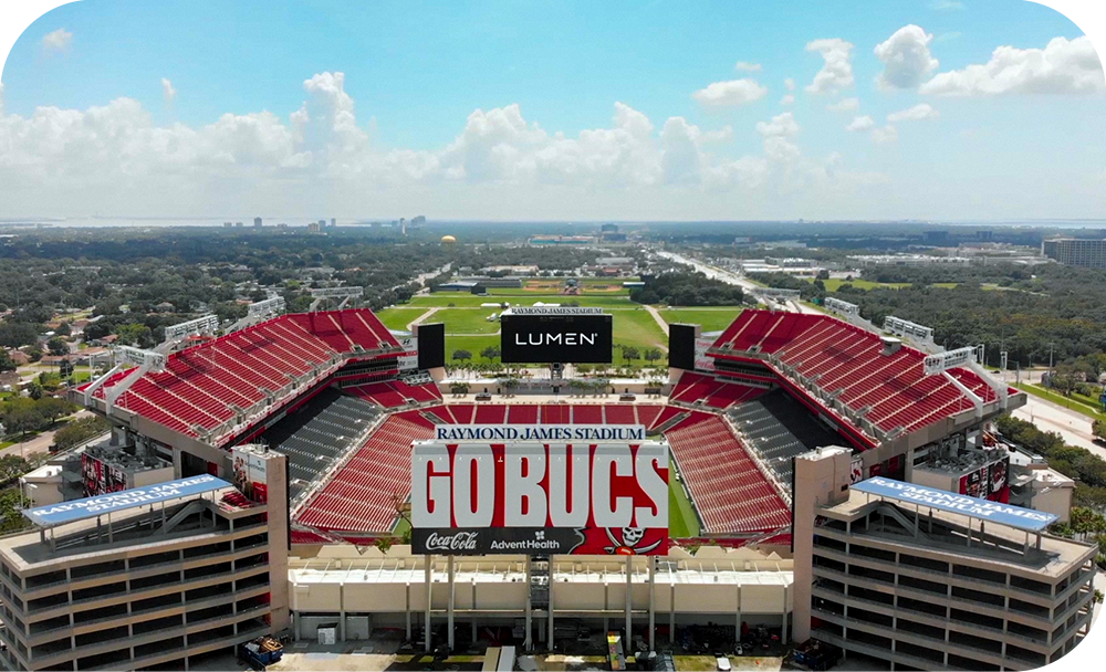 The Lumen logo is shown on a billboard in an overhead photo of Raymond James Stadium.