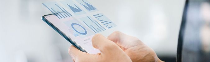 Close up of a pair of hands holding a mobile device with a reporting overlay