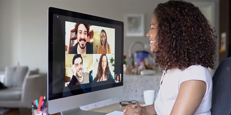 A woman meets with co-workers remotely. 