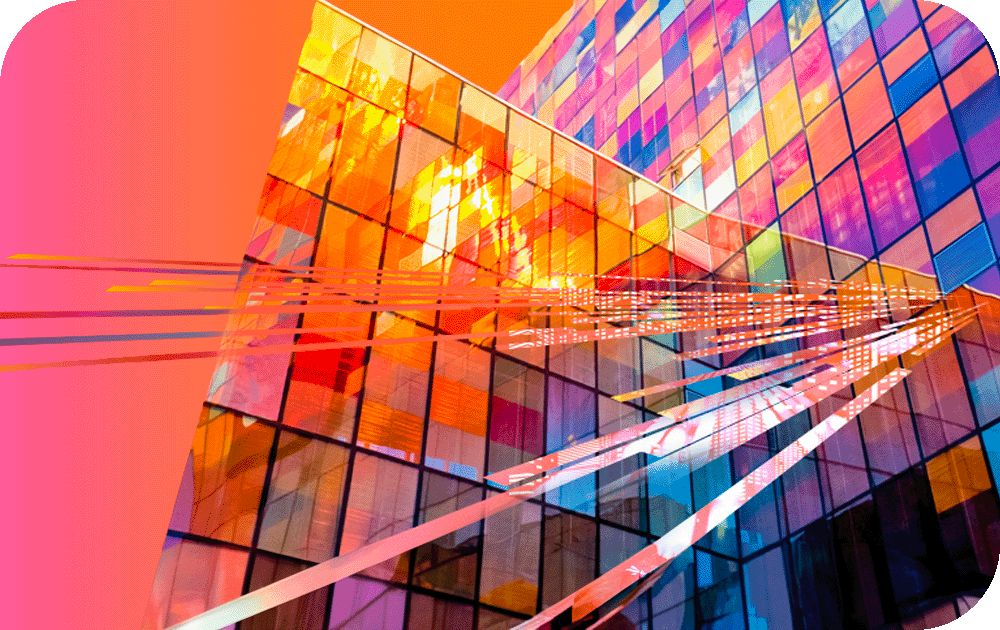 vibrant, abstract image of a modern glass building with many reflective windows in varying shades of orange, pink and blue and the illusion of beams of light reflecting from the windows 